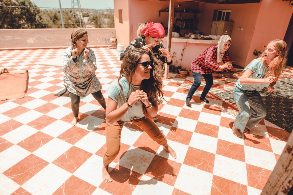 Annie Miller dancing with FRÉ Skincare team in Morocco