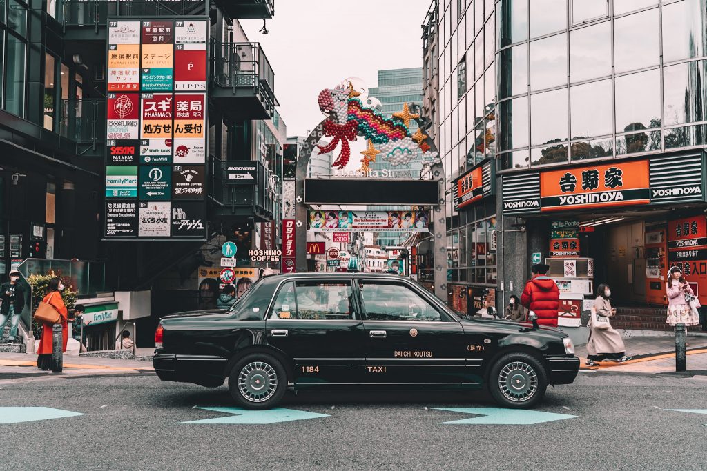 Car downtown in Tokyo, Japan by Annie Miller